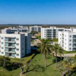 Complexo de apartamentos no Itapoã Parque, Brasília, com prédios modernos e áreas verdes, representando entrega de moradias pelo governo.